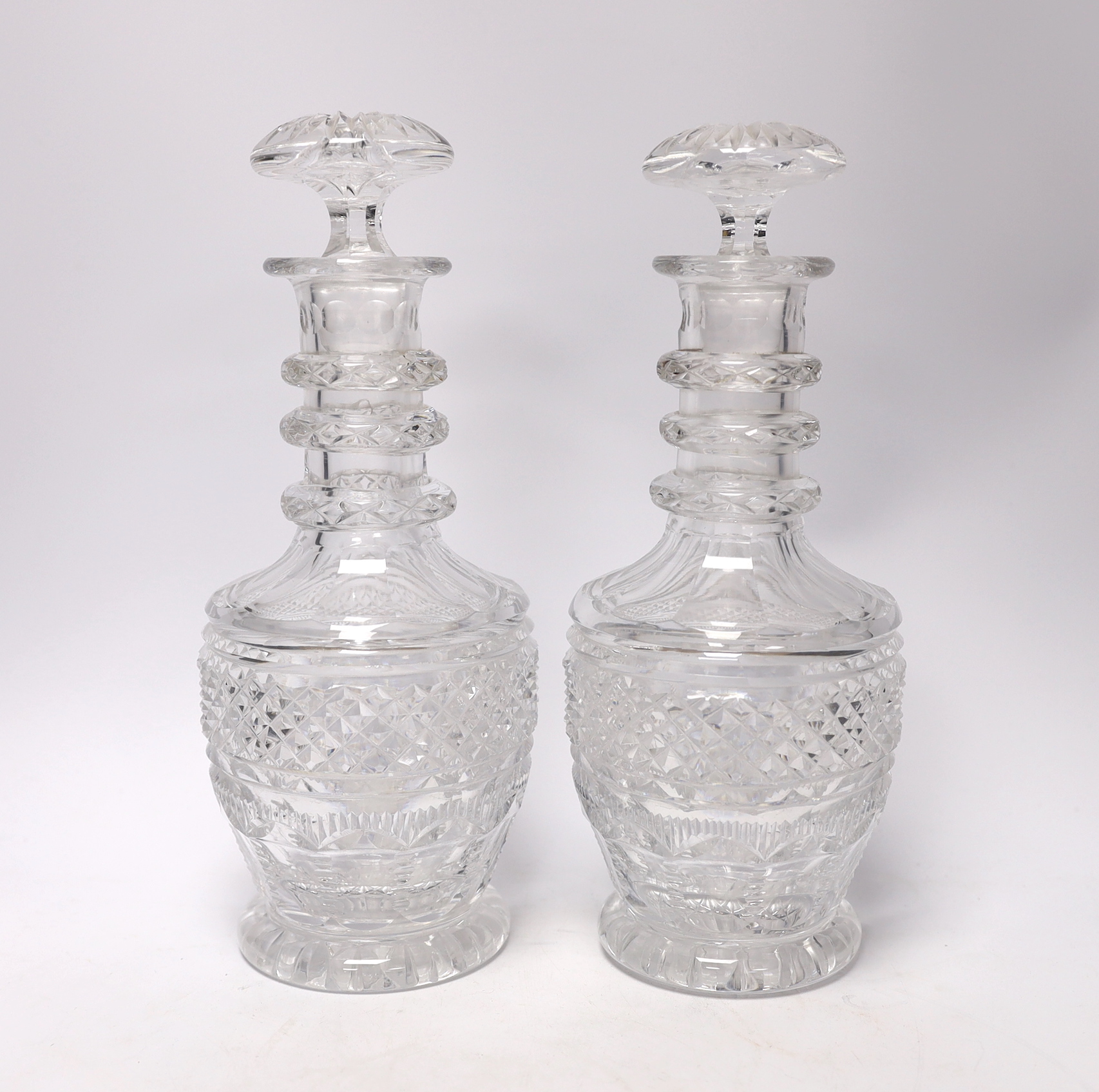 A pair of mid 19th century cut glass decanters and stoppers, 29cm